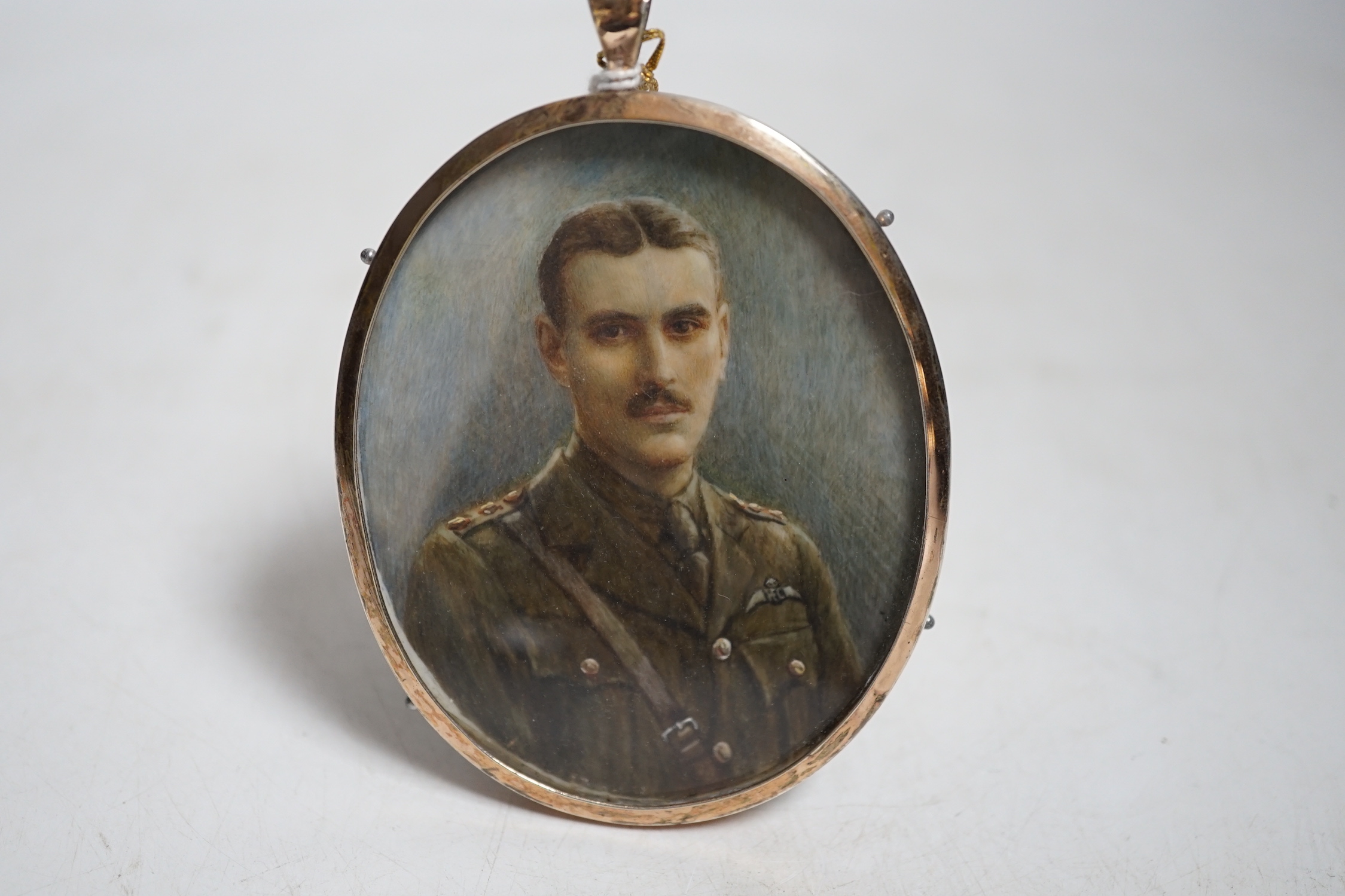 Miniature watercolour portrait on ivory of RFC officer Tom Abbot wearing military dress, with photograph of the sitter CITES Submission reference TPFS3A7Q